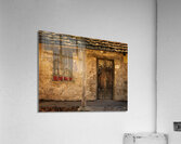 Rustic San Juan building with a barred window red flowers and a Acrylic Print