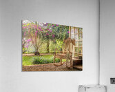 A vintage wooden rocking chair with a straw hat rests on a porch Impression acrylique