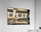 Old rake and mop against log cabin Acrylic Print