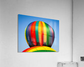 Colorful hot air balloon rising above another with blue sky Impression acrylique
