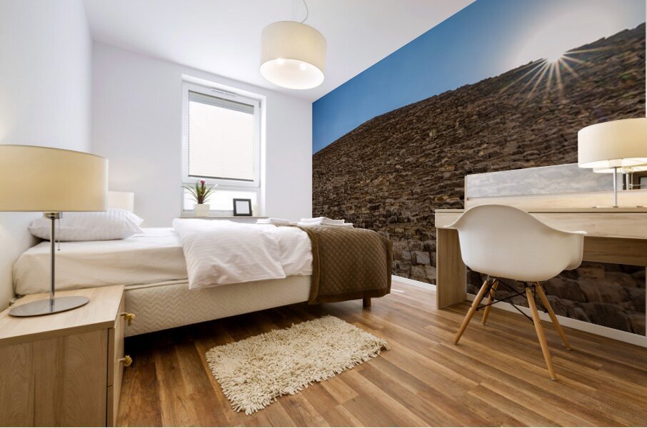 Great Pyramid of Giza with the sun flaring over the top edge Mural print