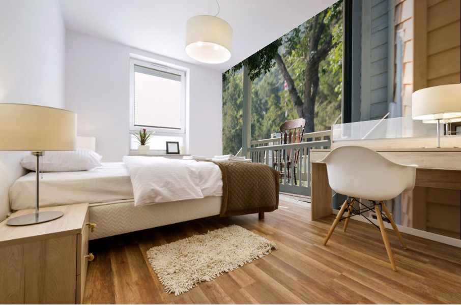 Wooden rocking chair on porch of old house Impression murale