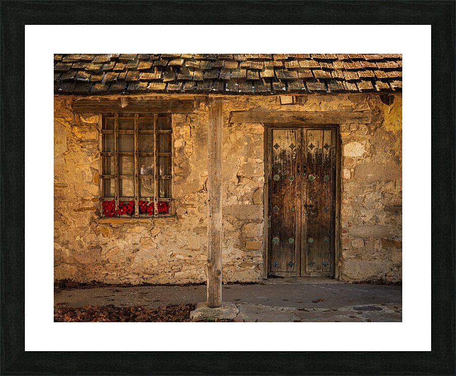 Rustic San Juan building with a barred window red flowers and a Picture Frame print