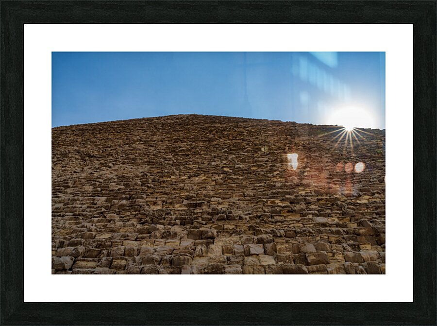 Great Pyramid of Giza with the sun flaring over the top edge Picture Frame print