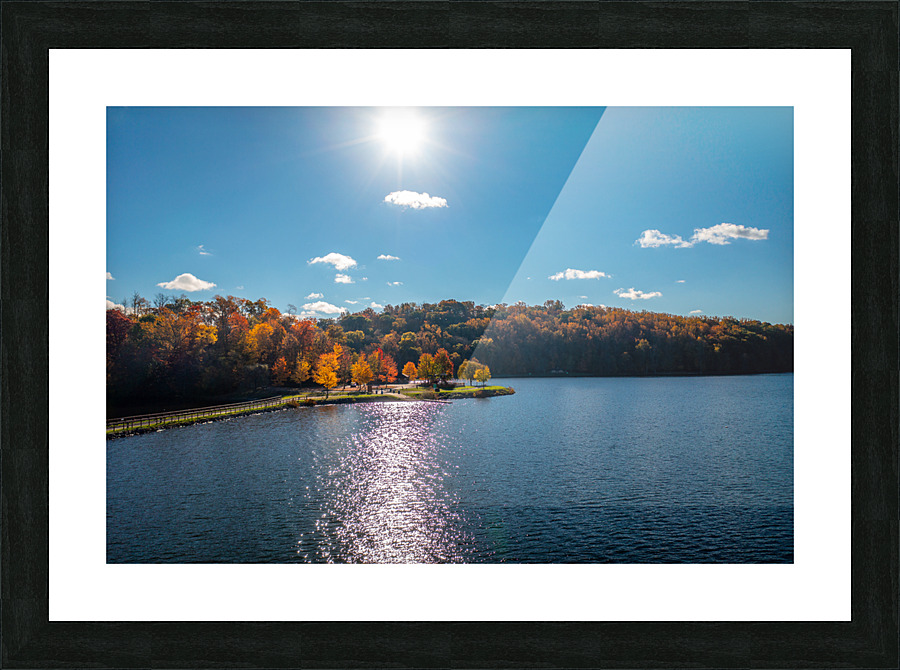 Sunburst above fall trees around the water at Cheat Lake Park Picture Frame print