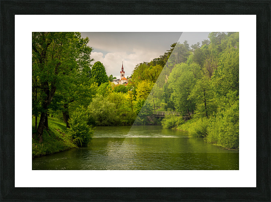 Church in the woods above peaceful river Picture Frame print