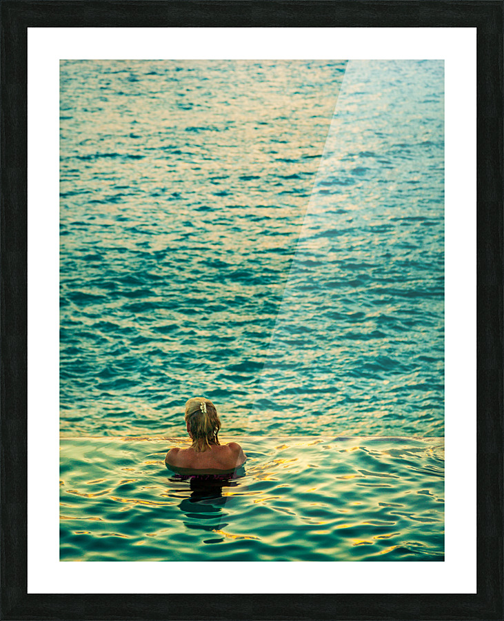 Womans head against infinity edge pool Picture Frame print