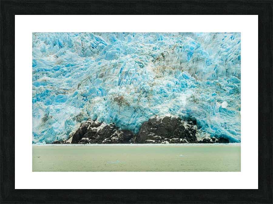 Amalia Glacier towers over large rocks and trees in Patagonia Picture Frame print