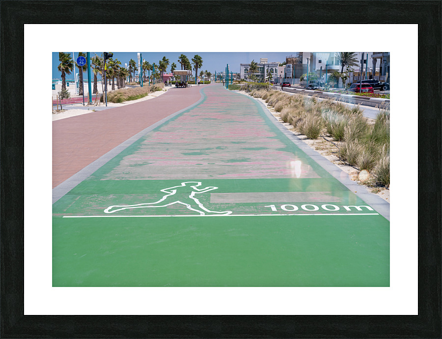 Rubber surface of running track alongside Dubai beach Picture Frame print