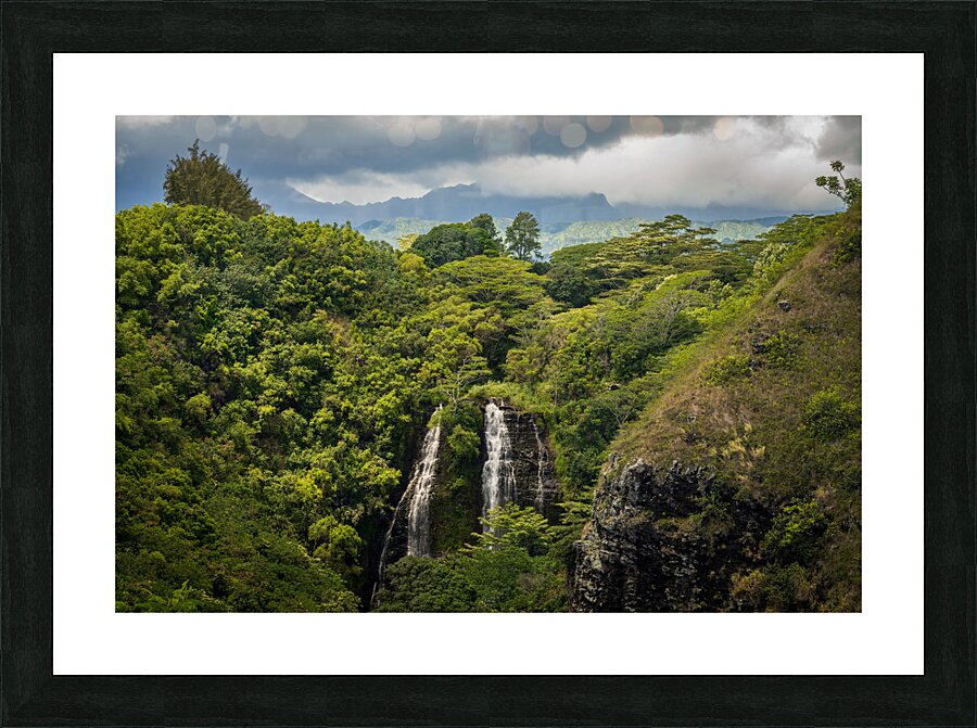 Opaekaa Falls sunlit as dark storm clouds gather over the hills Picture Frame print