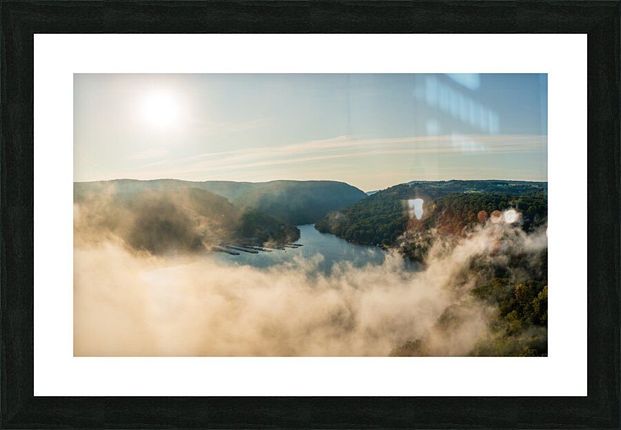 Mist rises from Cheat Lake in the early morning as the sun rises Picture Frame print