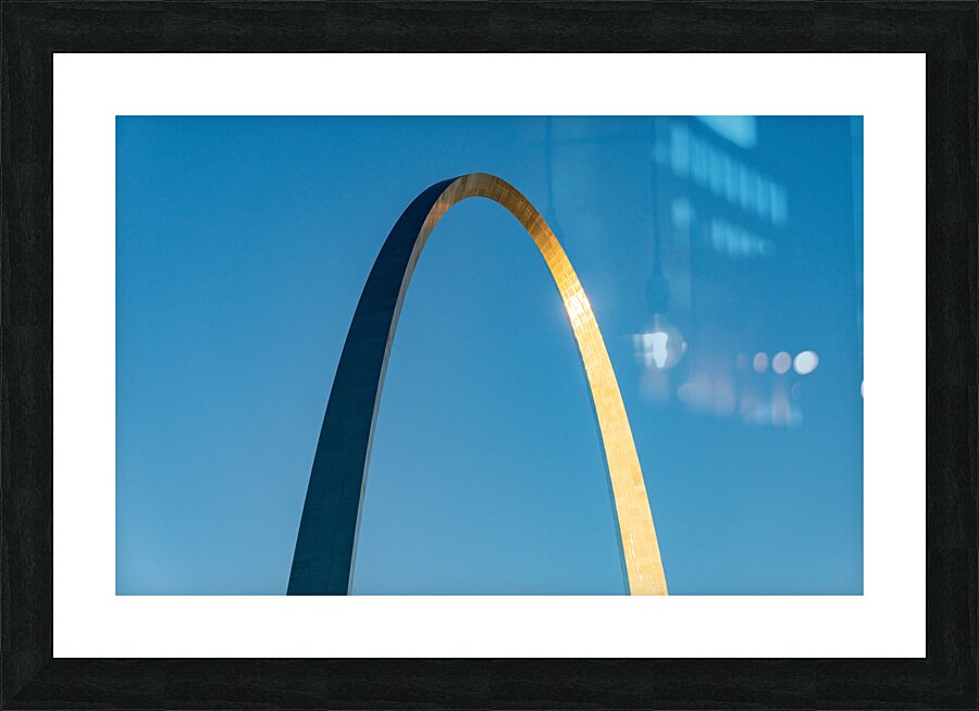 Unusual view of Gateway Arch at sunrise against blue sky Picture Frame print