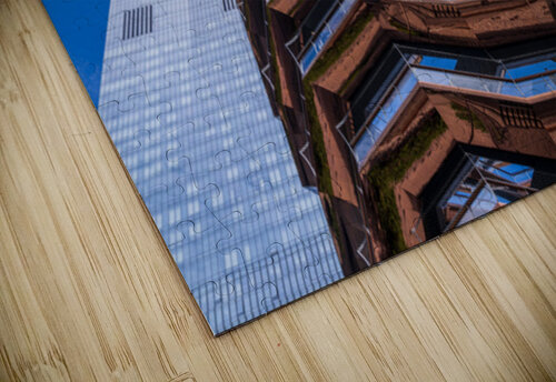 Reflective surface of the Vessel with a skyscraper behind with c Steve Heap puzzle