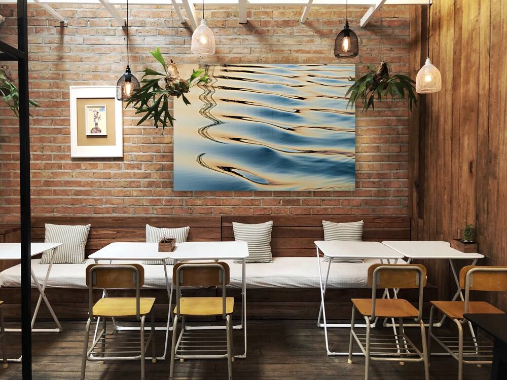 Reflections of electricity pylon at sunset in gentle river rippl Reproduction