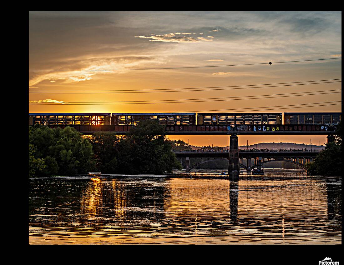 Freight train on the railroad bridge in Austin at sunset Reproduction