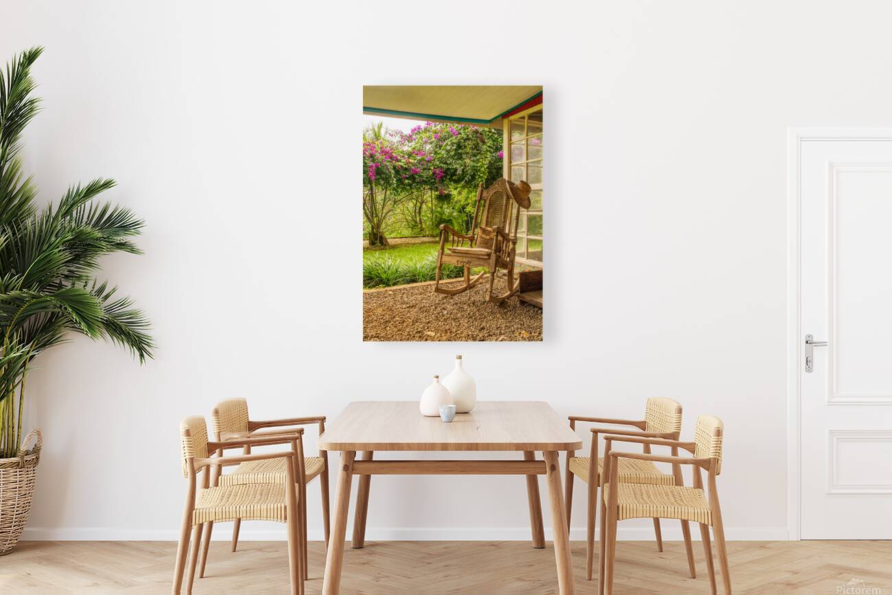 Portrait format of vintage wooden rocking chair on a porch Reproduction