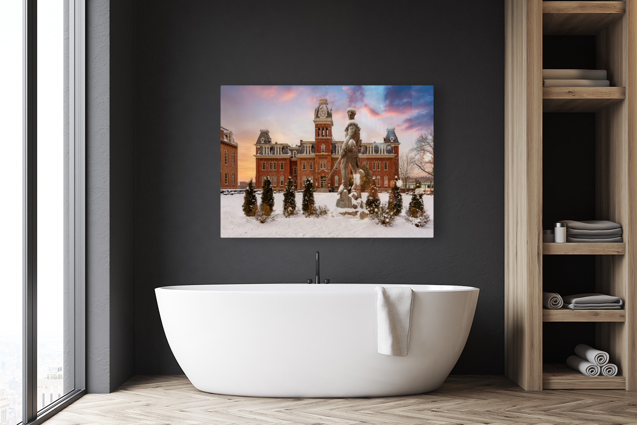 Mountaineer statue against Woodburn Hall Reproduction