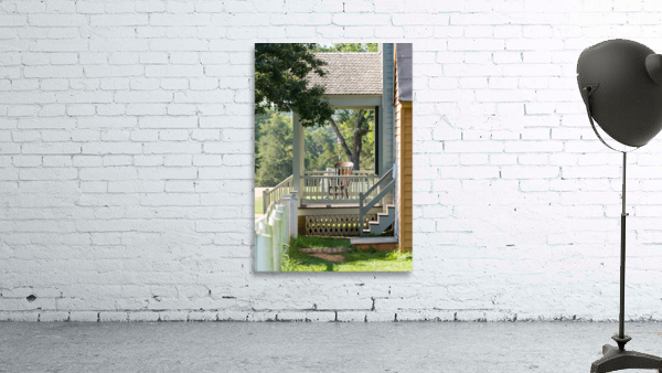 Wooden rocking chair on porch of old house Wall Preview