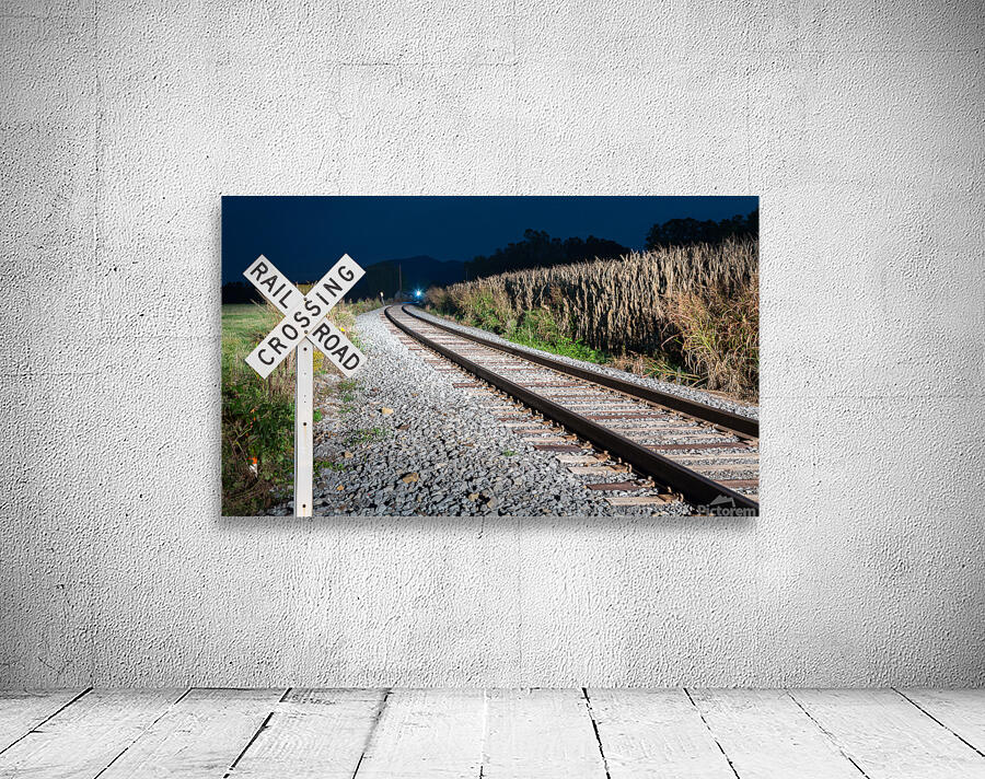 Oncoming train with railroad crossing sign Wall Preview