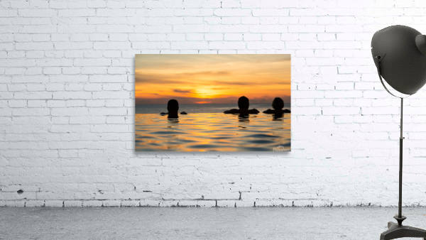 Silhouetted heads against infinity edge pool Wall Preview