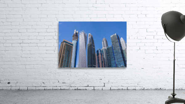 Cayan Tower among tall buildings on waterfront at Dubai Marina Wall Preview