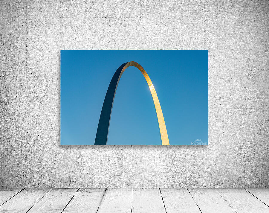 Unusual view of Gateway Arch at sunrise against blue sky Wall Preview