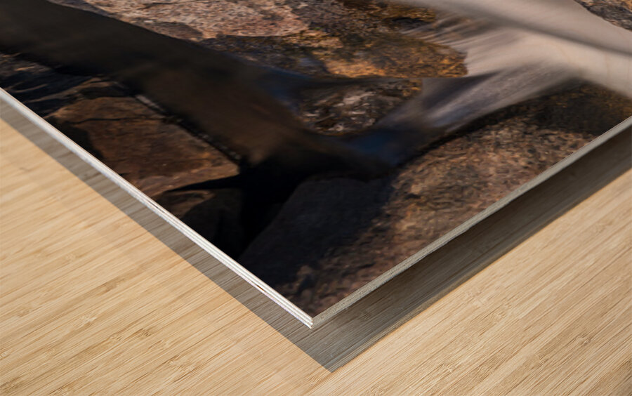 Pebbles balanced on rocks in raging river illustrating resilienc Wood print