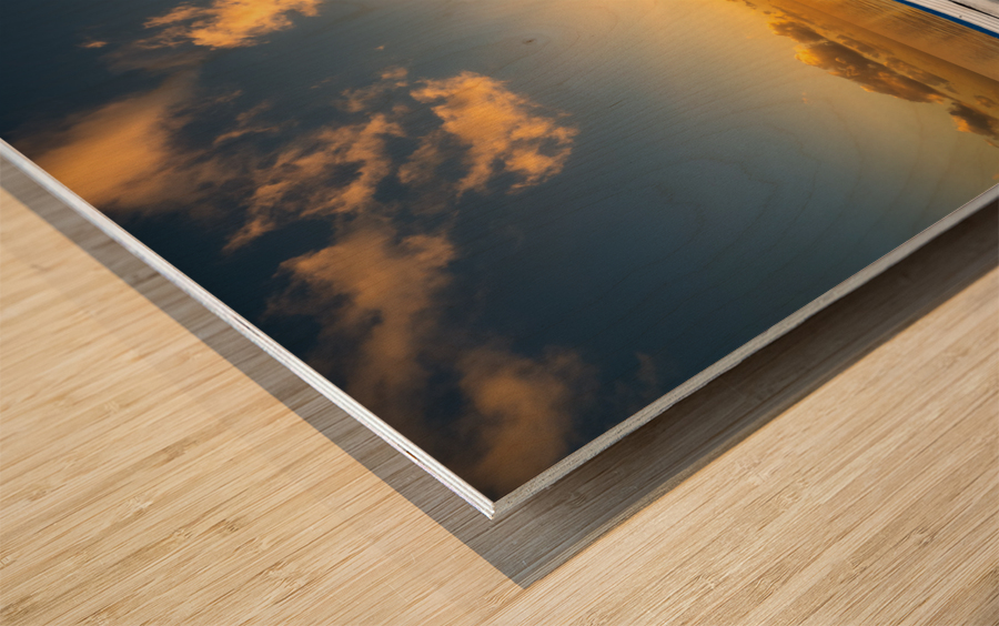 White rowing boat adrift on open ocean drifting to sunset Wood print