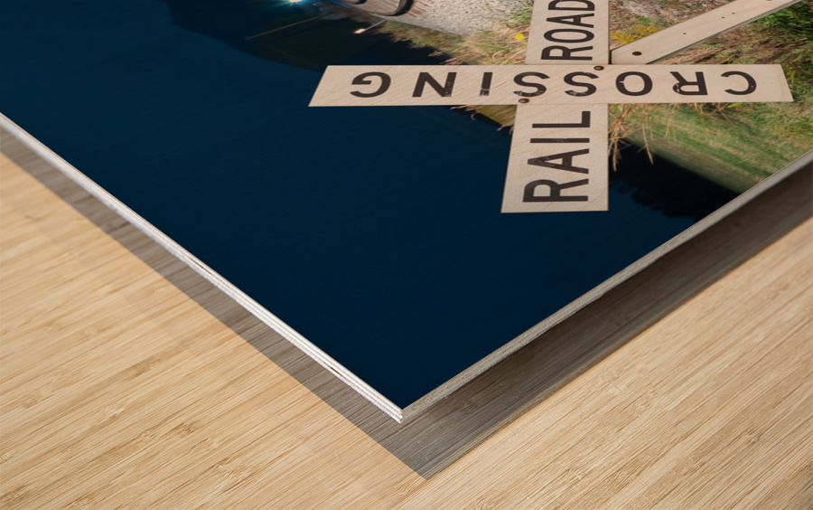 Oncoming train with railroad crossing sign Wood print