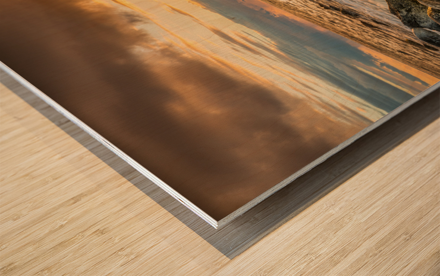 Sunset over rocks from Kee Beach Wood print