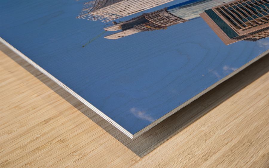 Cayan Tower among tall buildings on waterfront at Dubai Marina Wood print