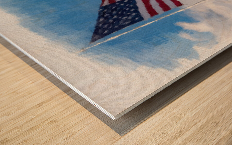 Digital art of USA stars and stripes flag against blue sky Wood print