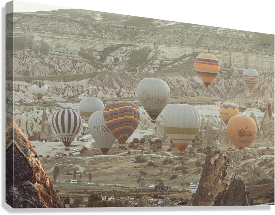  hot air balloons fly over the city of goreme at sunrise Canvas Print