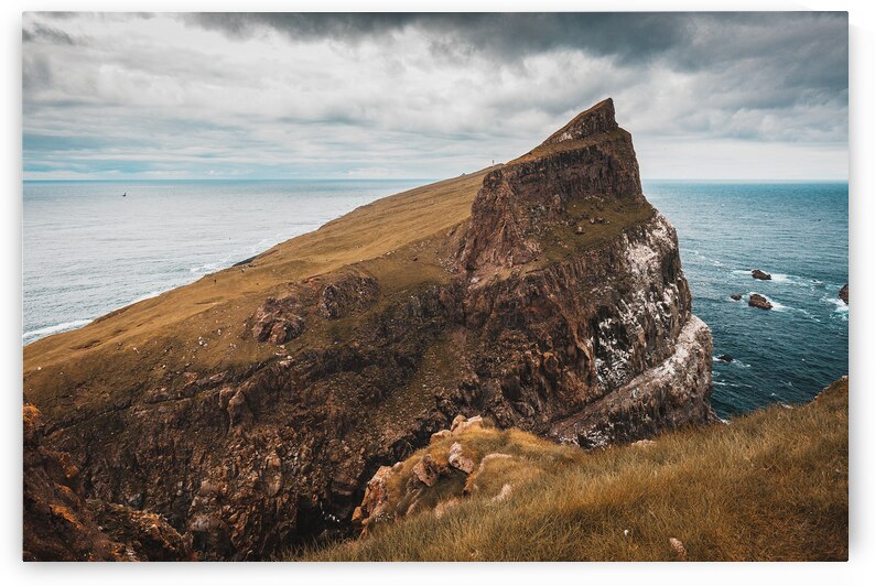 cliffs and the village on the island of Mykines Faroe. by Gualtiero Boffi