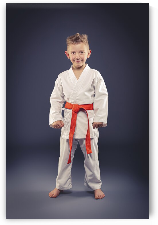 portrait of a smiling child with kimono practicing martial arts by Gualtiero Boffi