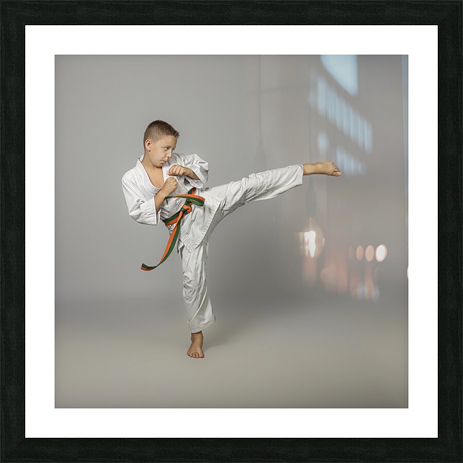 boy performs a side kick Picture Frame print
