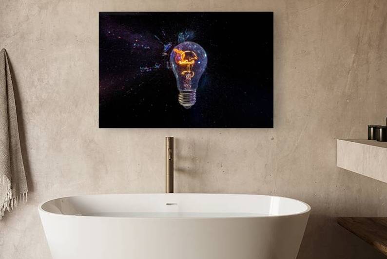 old bulb breaking into fragments on black  by Gualtiero Boffi