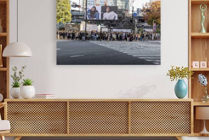 crowds of people prepare to cross the famous Shibuya Crossing by Gualtiero Boffi