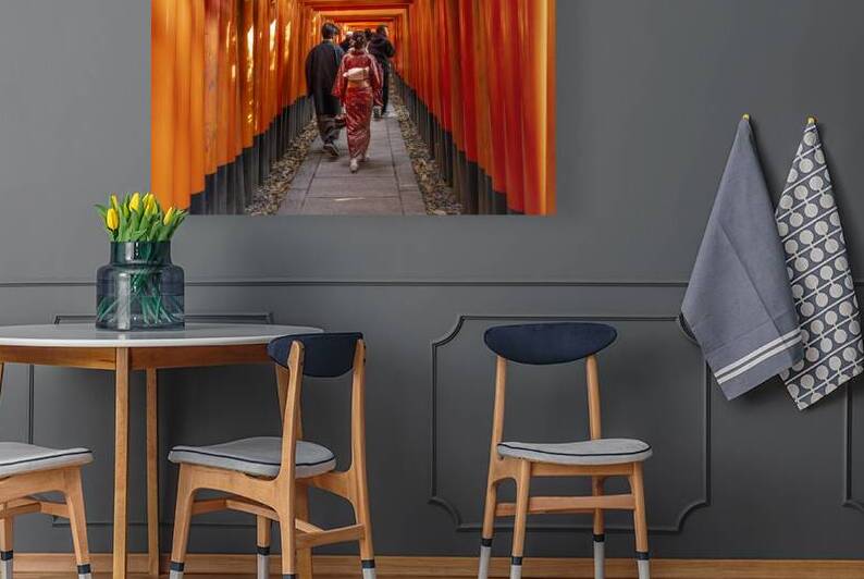 People pass under the torii of the Fushimi inari temple by Gualtiero Boffi
