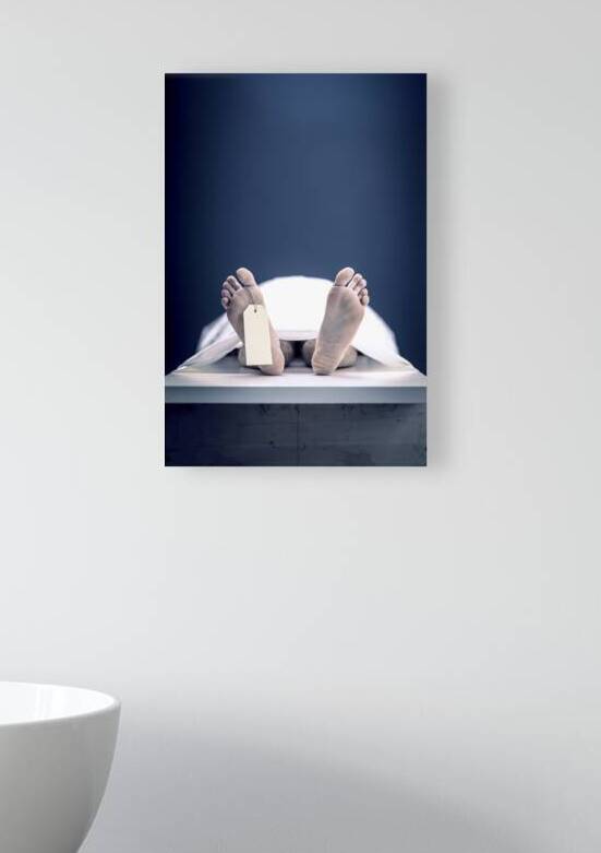 feet with dead mans tag in mortuary background by Gualtiero Boffi