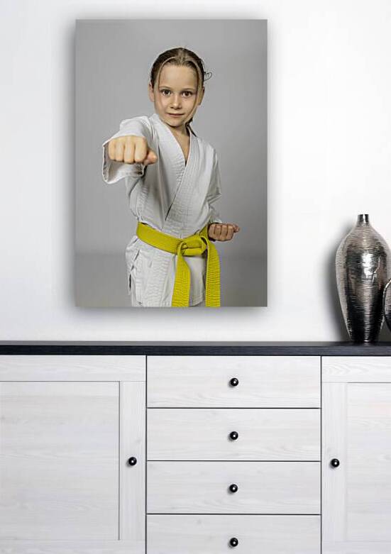 Caucasian girl practises karate by Gualtiero Boffi