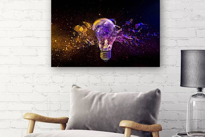 light bulb shattering on black background.  by Gualtiero Boffi