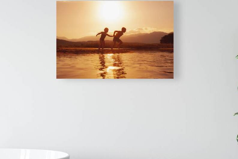 children run happily on the beach  by Gualtiero Boffi
