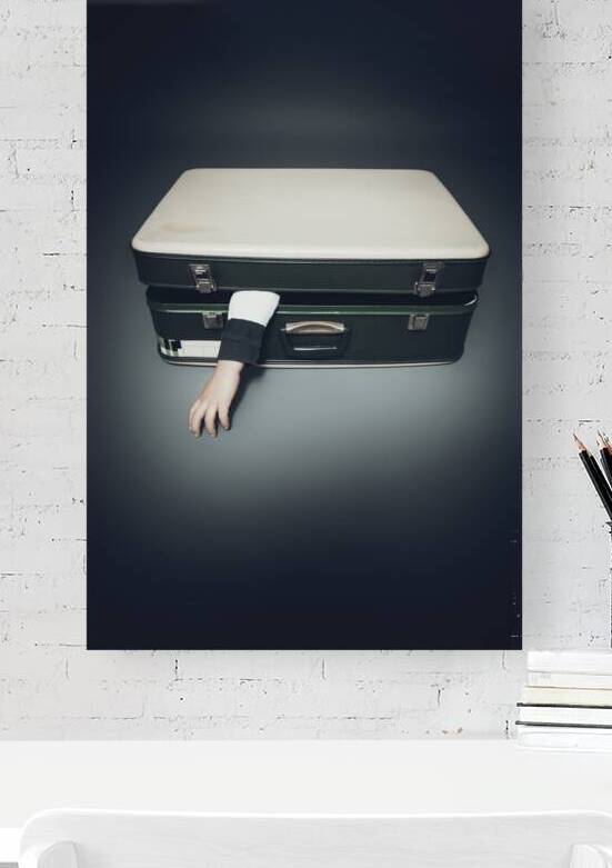 arm sticks out of an suitcase by Gualtiero Boffi
