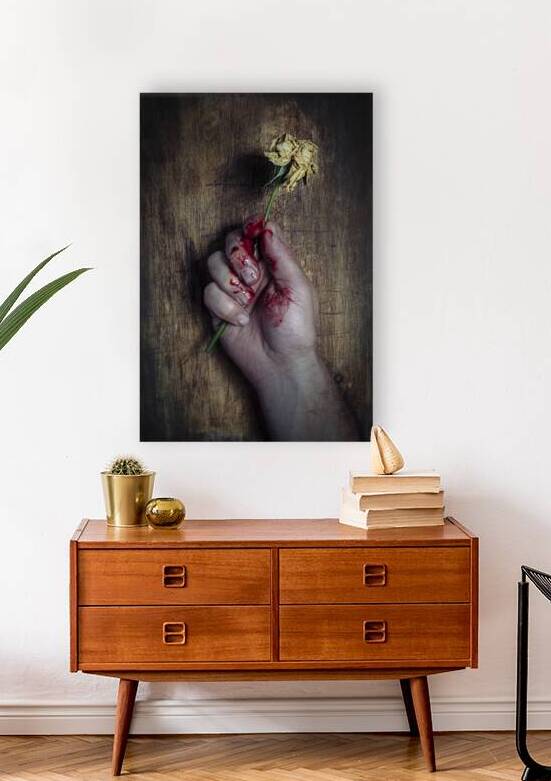 hand clutches a withered rose by Gualtiero Boffi