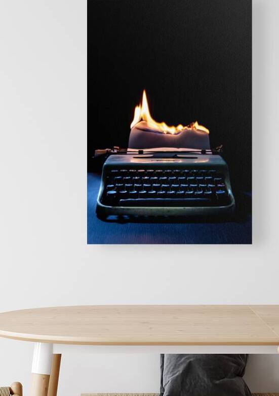 typewriter and sheet of paper catching fire by Gualtiero Boffi