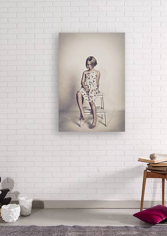 sad little girl sits on a stool  by Gualtiero Boffi