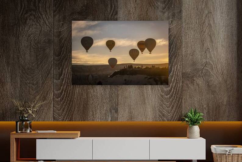 Hot air balloons fly at dawn over the hills of Goreme. by Gualtiero Boffi
