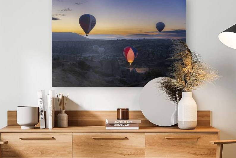 Hot air balloons fly at dawn over the hills of Goreme. by Gualtiero Boffi