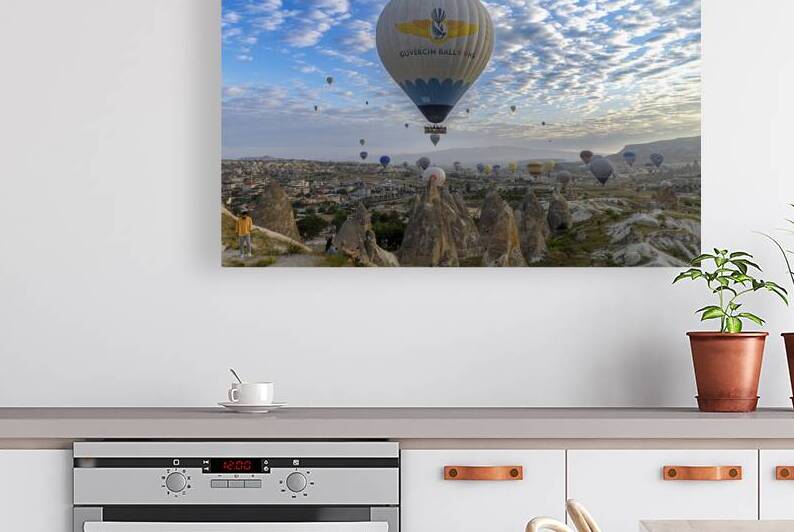 hot air balloons rise into the sky at dawn in the valleys of cap by Gualtiero Boffi